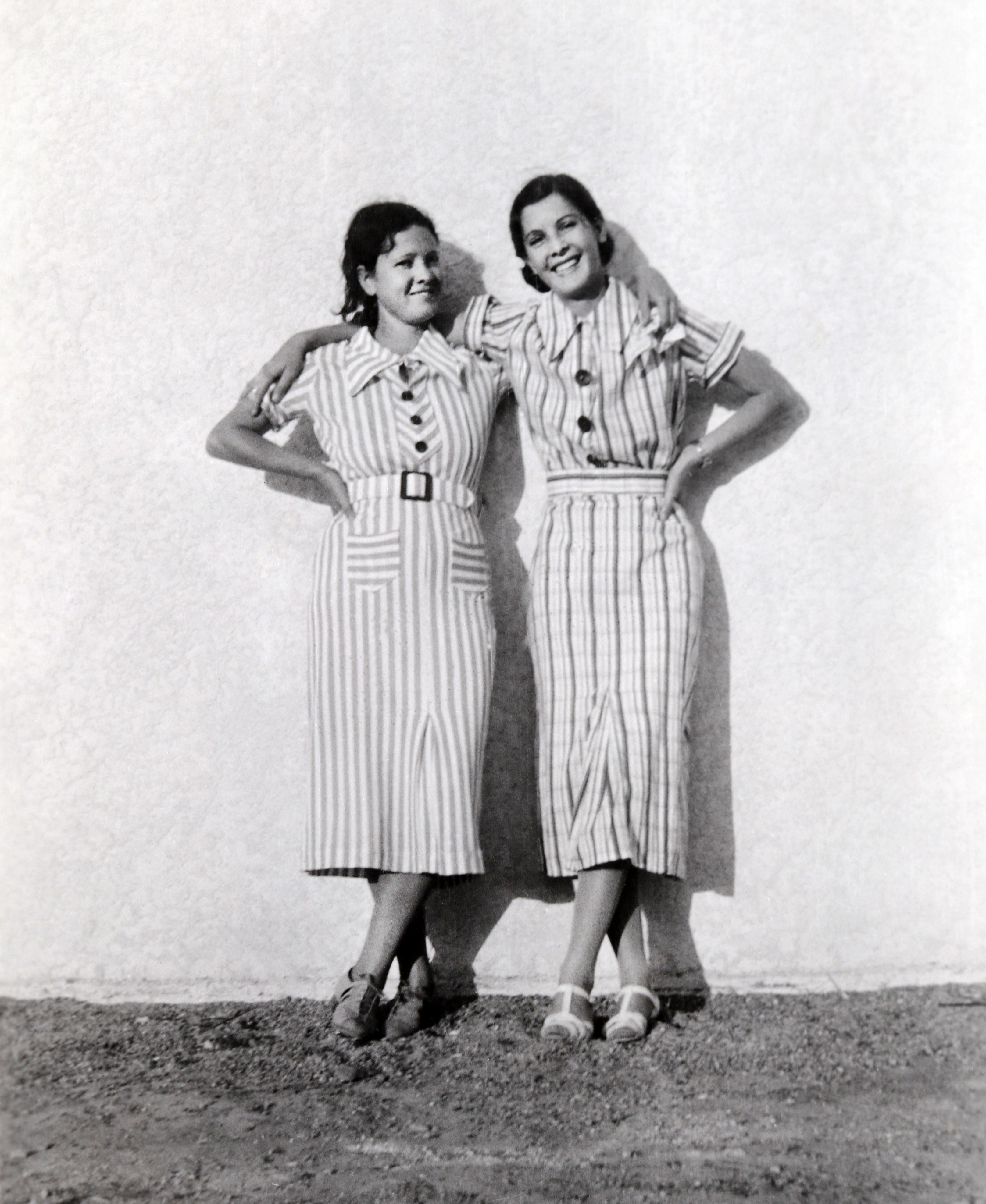 Two young women modeling almost identical striped dresses at a fashion show in Albuquerque's Old Town District, Albuquerque, New Mexico, 1934. (Photo by Buddy Mays/Getty Images)