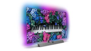 A Philips TV displaying a piano and flowers.