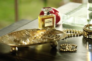 A bottle of Chanel No.5 perfume and Chanel jewelry