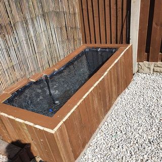 bathtub makeover into pond with wooden frames