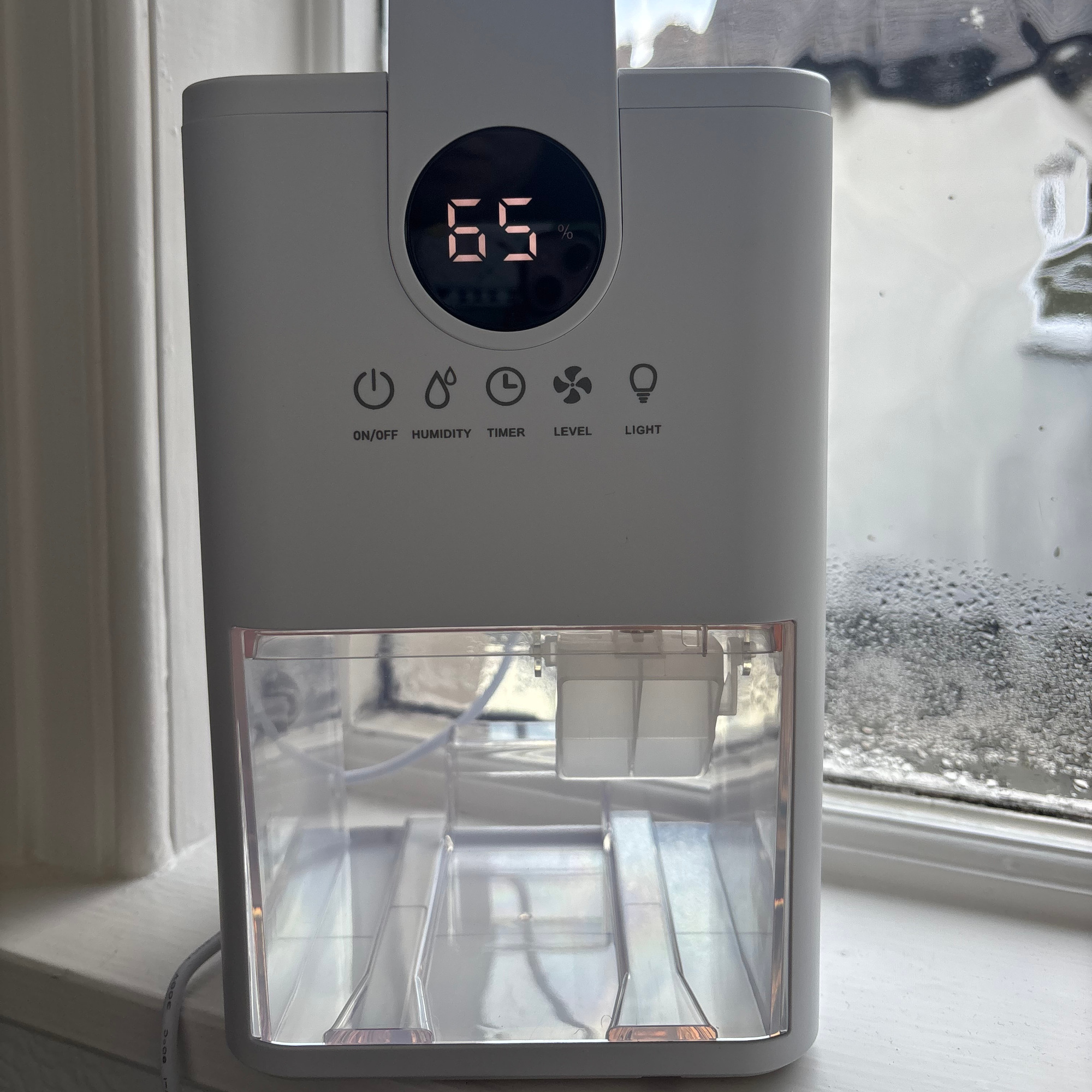 tcp dehumidifier on a window sill with condensation