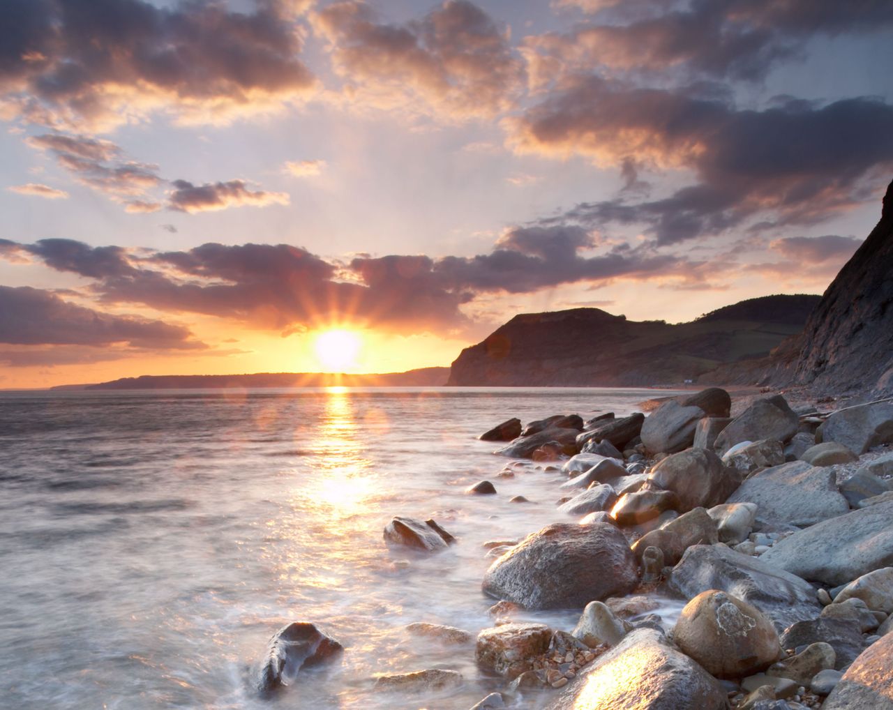 The Jurassic coast at sunset with &#039;Golden Cap&#039; in the distance, Dorset, England, UK.