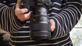Nikon Z 135mm f/1.8 S Plena lens in the hand