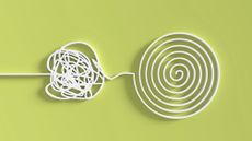 Tangled white wire leading to an untangled circle of wire on a bright green background