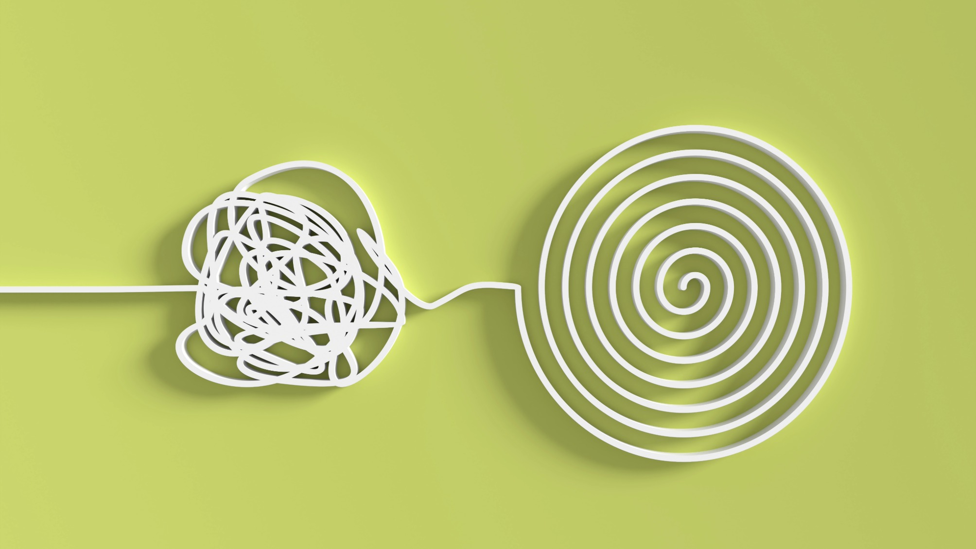 Tangled white wire leading to an untangled circle of wire on a bright green background