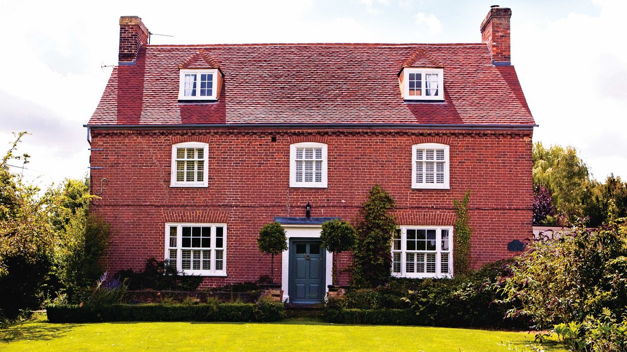 18th-century farmhouse with traditional red brick exterior