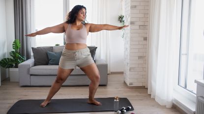 Woman performs low-impact workout at home