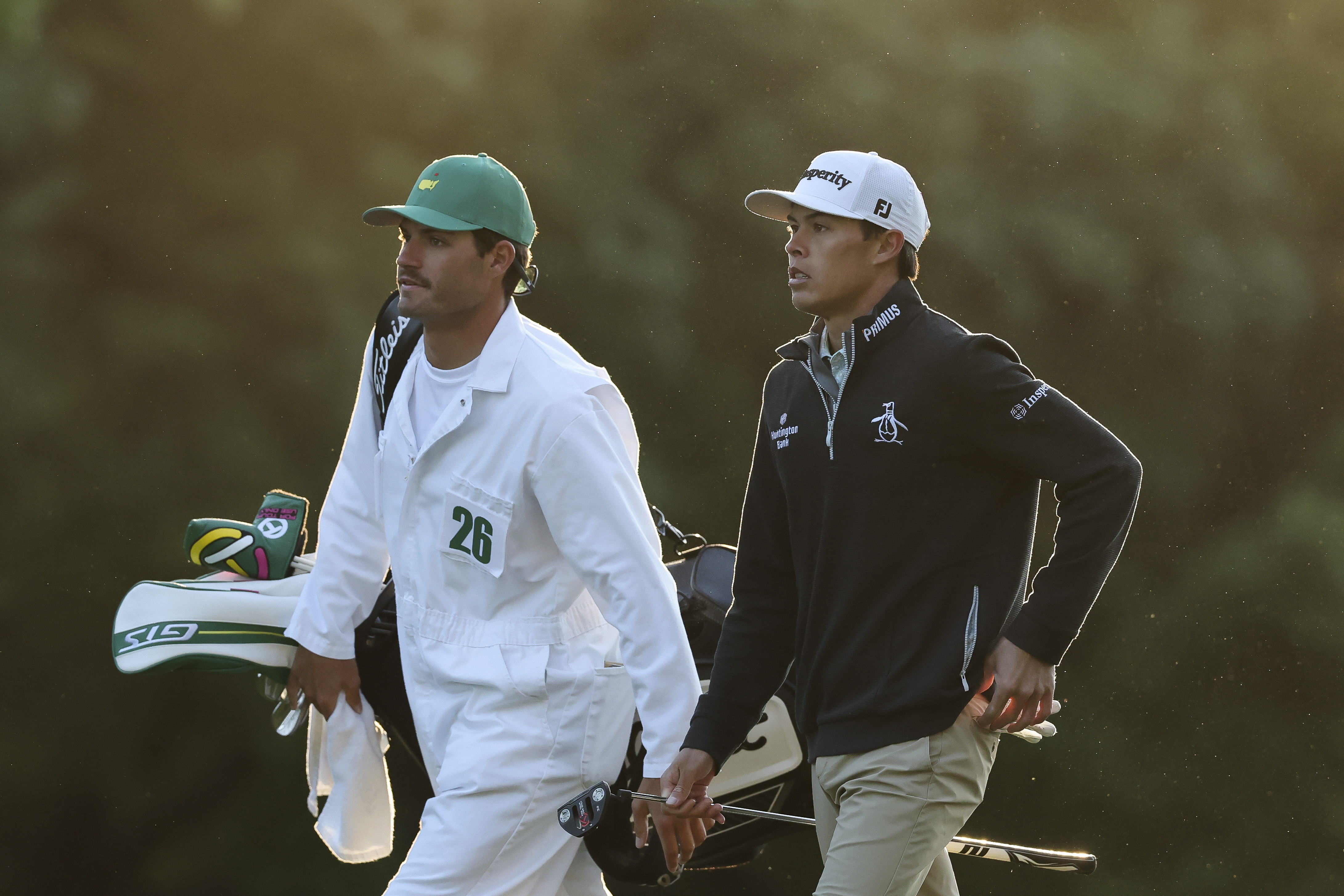 Johnny Keefer walks the first fairway with his caddie Joe Muschong during the first round of the 2026 Masters Tournament at Augusta National Golf Club