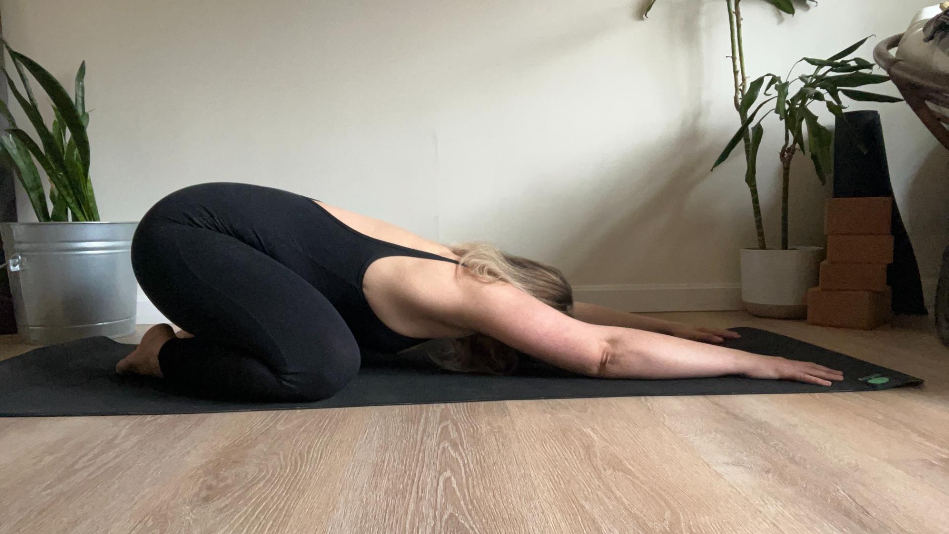 Woman performing yoga at home