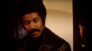 Michael Jai White wears a serious look and a leather jacket in Black Dynamite.