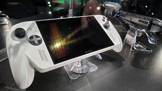 ASUS ROG Xbox Ally (white) and ROG Xbox Ally X (black) in a glass display case at Gamescom in August, 2025.