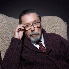 Tim Curry as Criminologist Narrator in THE ROCKY HORROR PICTURE SHOW: LET'S DO THE TIME WARP AGAIN