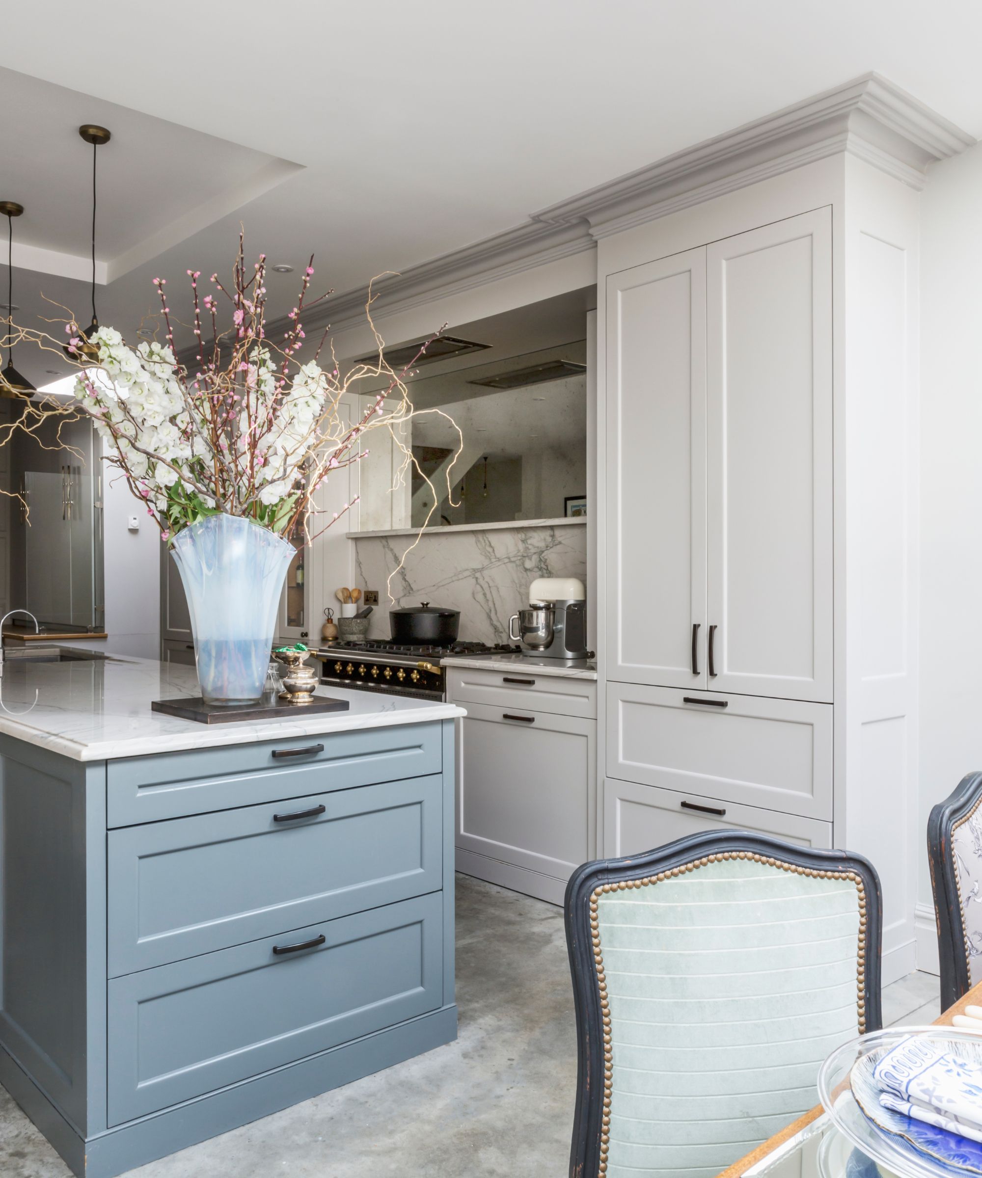 White kitchen with blue kitchen island