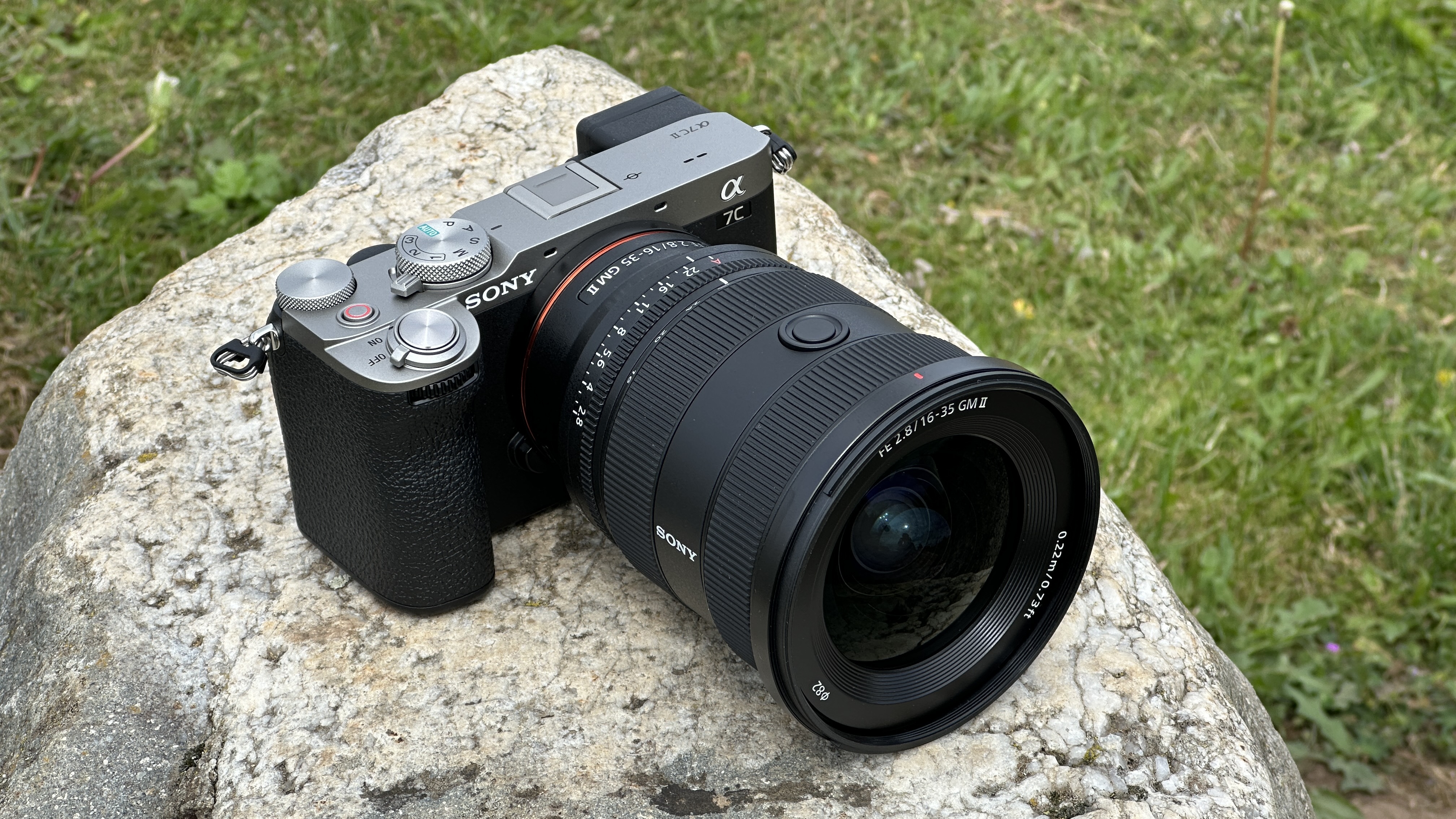 Sony A7C II mirrorless camera outside on a rock with Sony FE 16-35mm F2.8 GM II lens attached