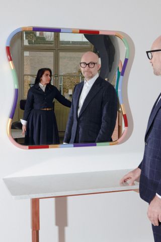 Nipa Doshi and Jonathan Levien reflected in mirror with coloured border
