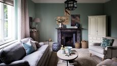 Light blur living room, comfy sofa, cushions, oval table, armchair, cupboard, paintings
