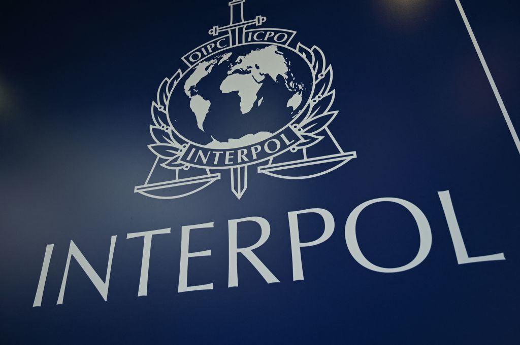 Interpol logo and text, white on a blue background