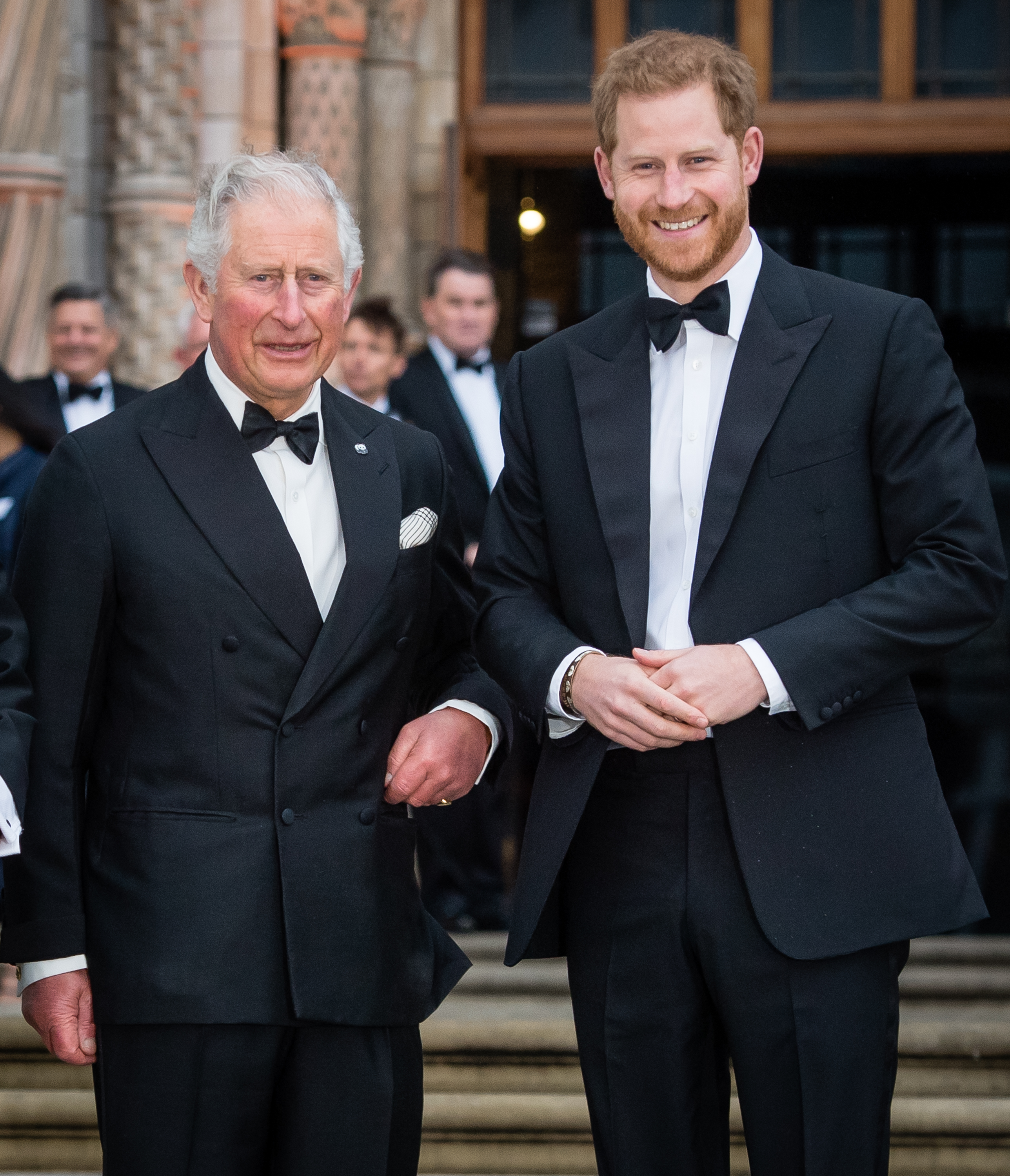 King Charles and Prince Harry wearing tuxedos and smiling
