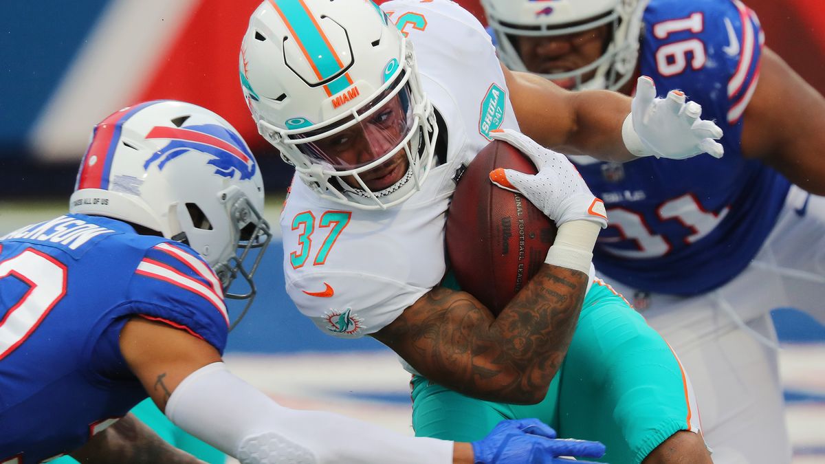 Myles Gaskin #37 of the Miami Dolphins is tackled by Dane Jackson #30 of the Buffalo Bills at Bills Stadium on Jan. 3, 2021 in Orchard Park, New York.