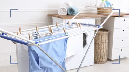 A white laundry room drying clothes with an an ironing board to raise the question is a dehumidifier good for drying clothes