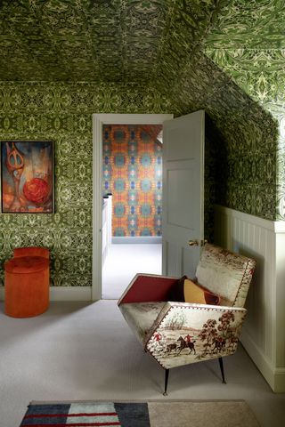 Small loft bedroom with green patterned wallpaper on ceiling