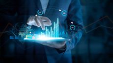 man looking at charts on tablet