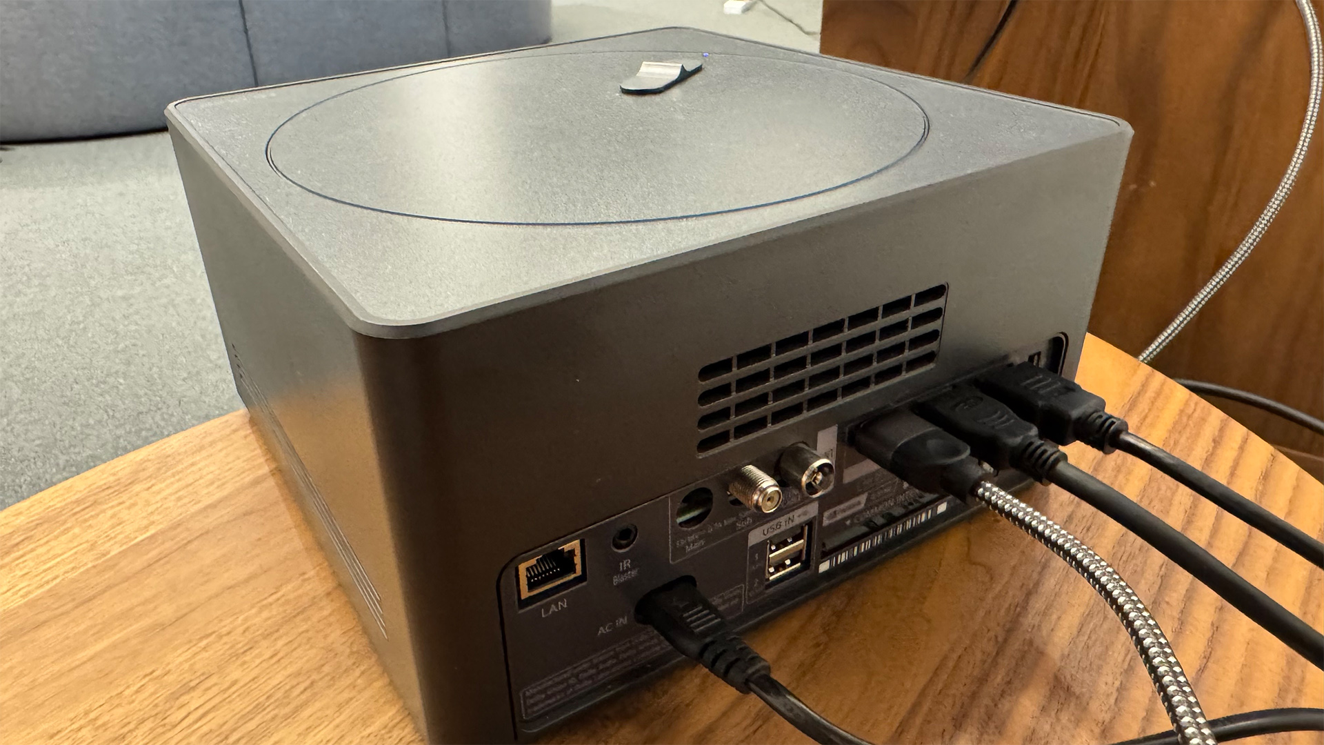 The 65-inch LG M5 OLED TV pictured mounted to a grey wall.