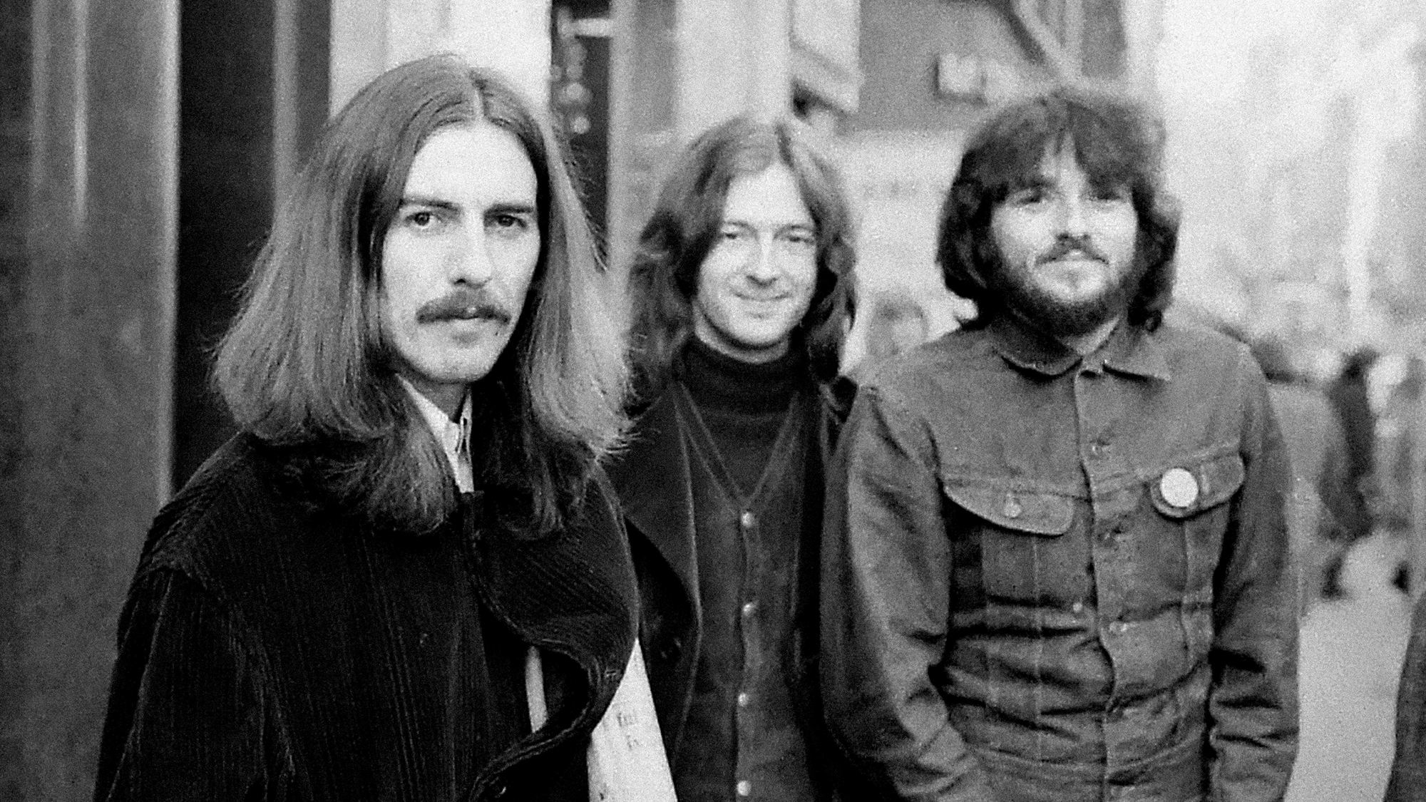 George Harrison, Eric Clapton and Delaney Bramlett, of Delaney &amp;amp; Bonnie, leave the Midland Hotel, in Birmingham, England, on their way to perform at the Town Hall, December 3, 1969. Bramlett would come to own both the 1913 Gibson Style O played by Harrison and Clapton, as well as Harrison's Rosewood Fender Telecaster, used during the Beatles' sessions for Let It Be.