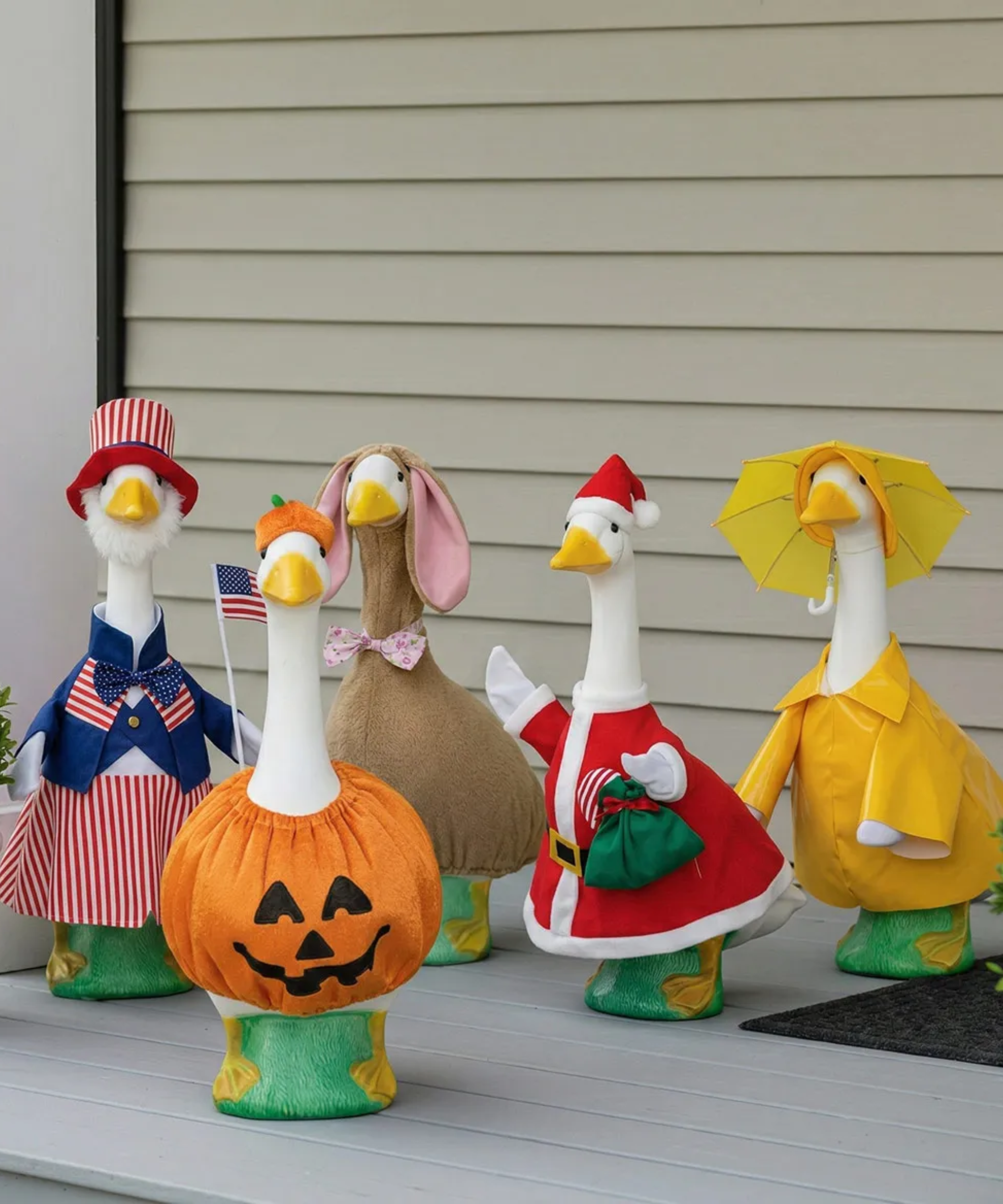 an assortment of porch geese in costumes