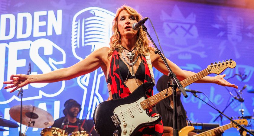 Ana Popovic stretches her arms out wide as she works the crowd during a 2024 show in Norway. She is playing her trust Fender Strat