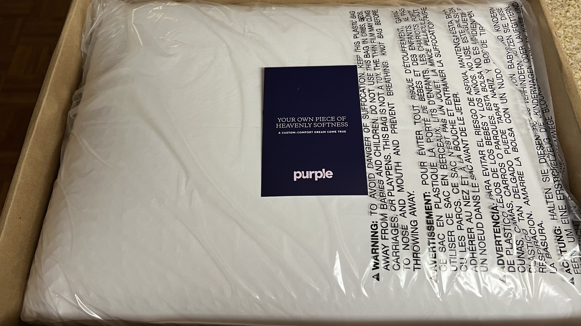 Purple DreamLayer pillow pictured in box