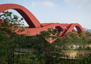 Red bridge structure through the trees