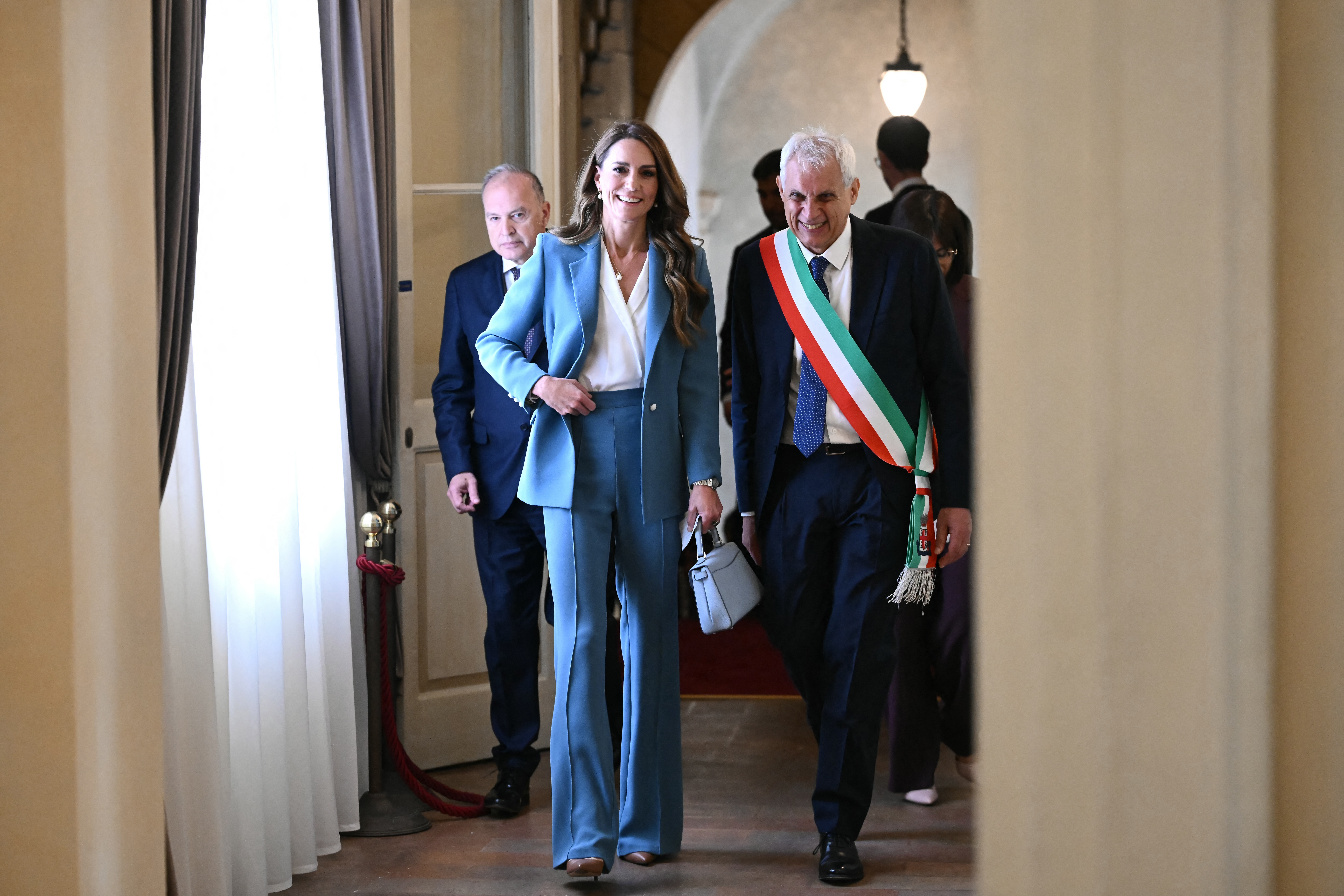 Catherine, Princess of Wales walks along with the mayor of Reggio Emilia, at Reggio Emilia's town hall as part of a two-day visit in Italy, on May 13, 2026. (Photo by Marco BERTORELLO / POOL / AFP)