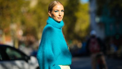 woman in blue turtleneck designer sweater