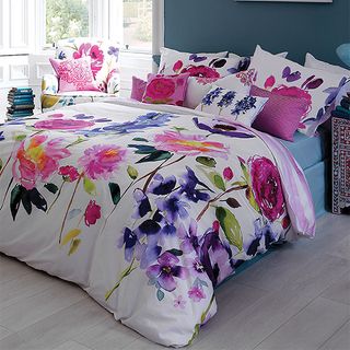 bedroom with floral duvet wooden floor