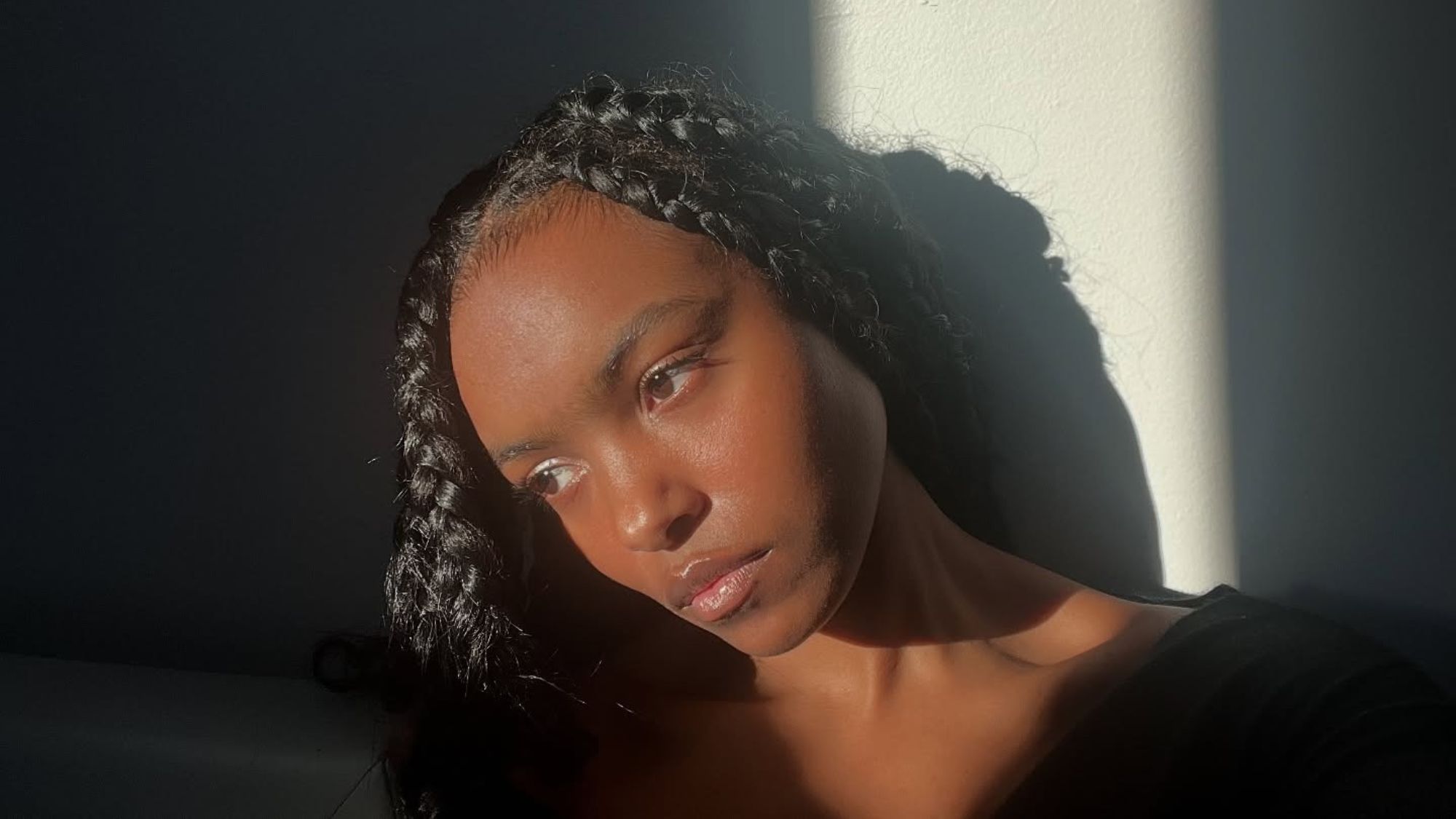 A selfie of Destiny Joseph posing in front of a stream of light.