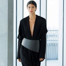 a model wearing a black tailored suit from tove's ss26 collection