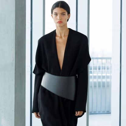 a model wearing a black tailored suit from tove's ss26 collection