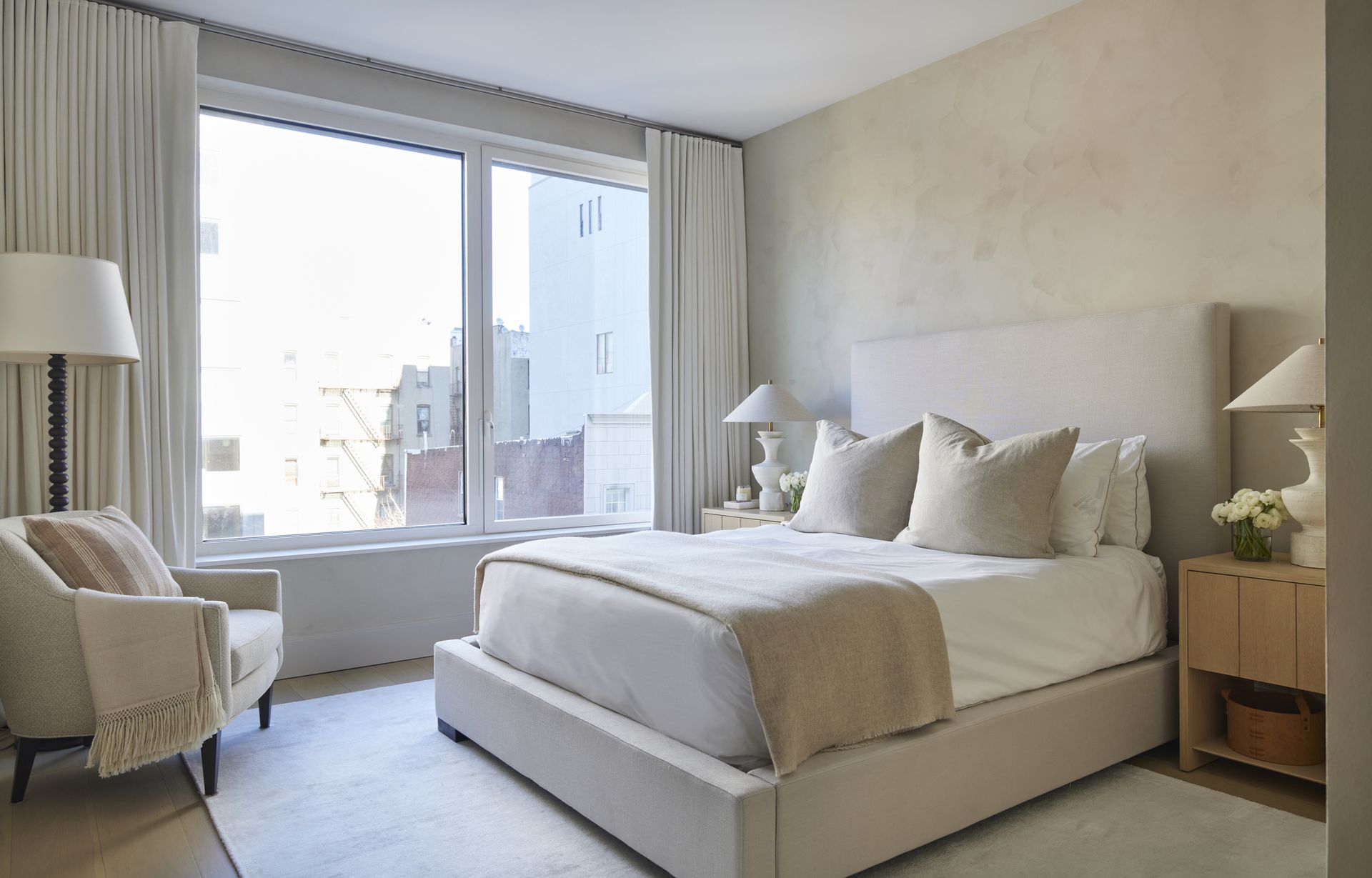 minimalist bedroom in neutral colors with limewash walls