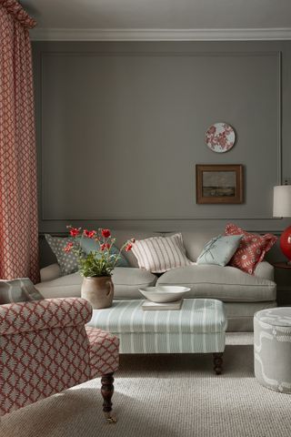Grey living room with grey Vanessa arbuthnott Bibury sofa and red accent colors