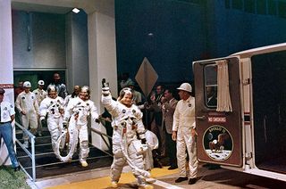 Neil Armstrong (right), seen on July 16, 1969, leads his Apollo 11 crewmates Buzz Aldrin and Michael Collins out of the Operations and Checkout Building as they leave to launch on mankind's first moon landing mission.