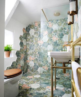 green botanical hexagonal shaped tiles laid in shower area and across floor