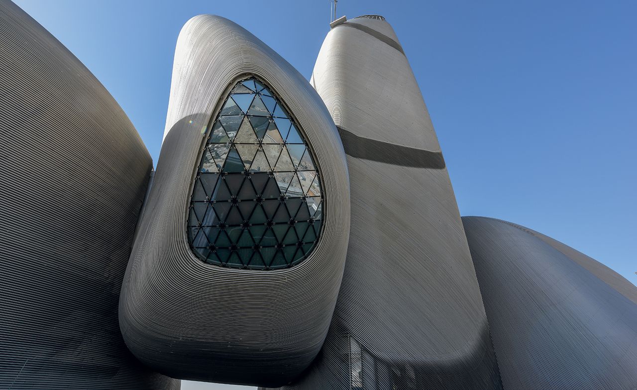 The facade is veiled by 360km of thin stainless steel pipe