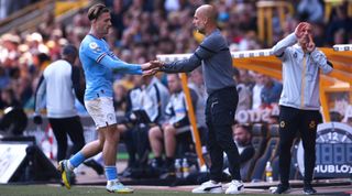 Jack Grealish of Manchester City is congratulated by Manchester City manager Pep Guardiola after being substituted during the Premier League match between Wolverhampton Wanderers and Manchester City at Molineux on September 17, 2022 in Wolverhampton, England.