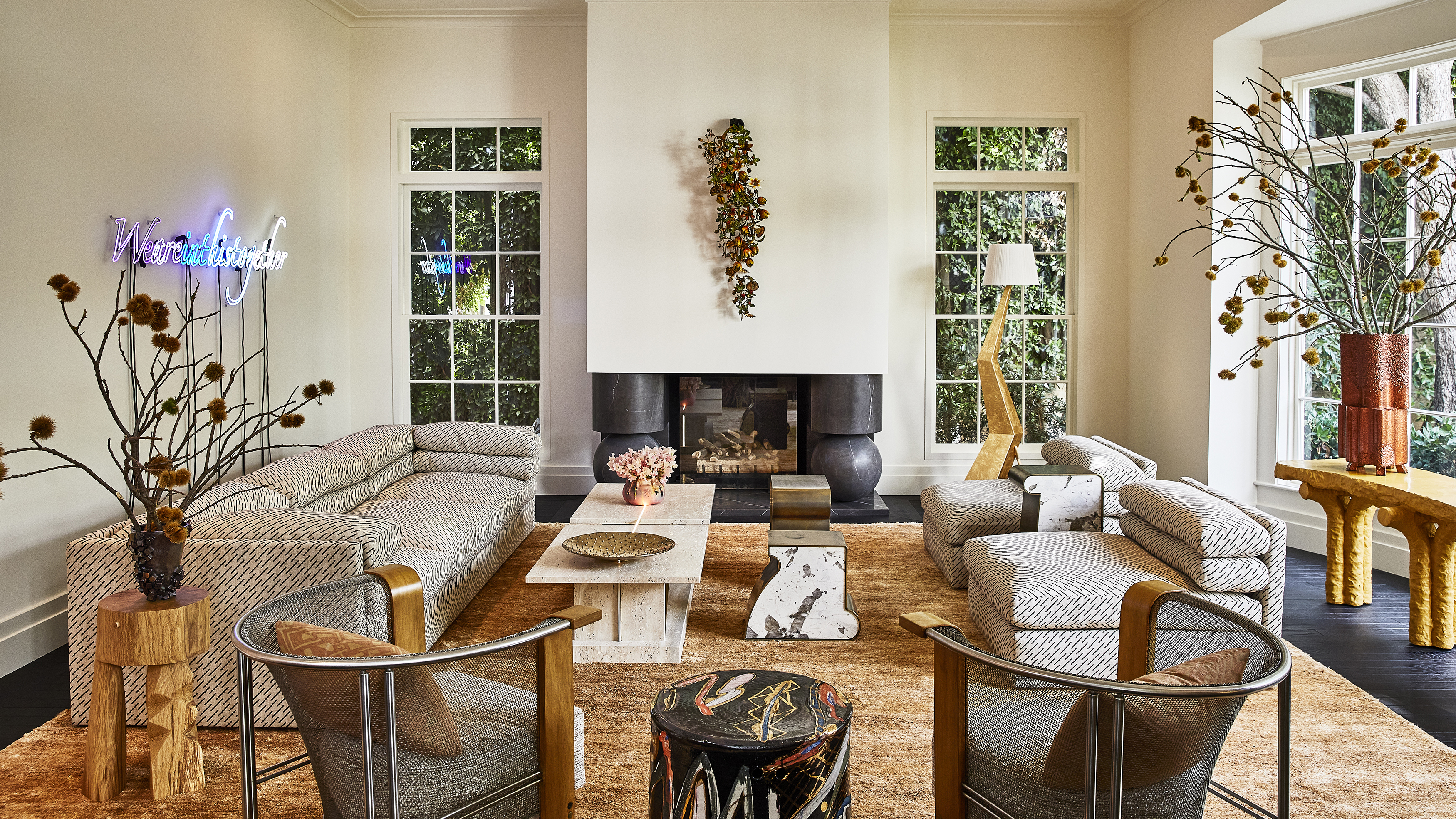 large cream living room with symmetrical layout but a mox of modern and vintage furniture