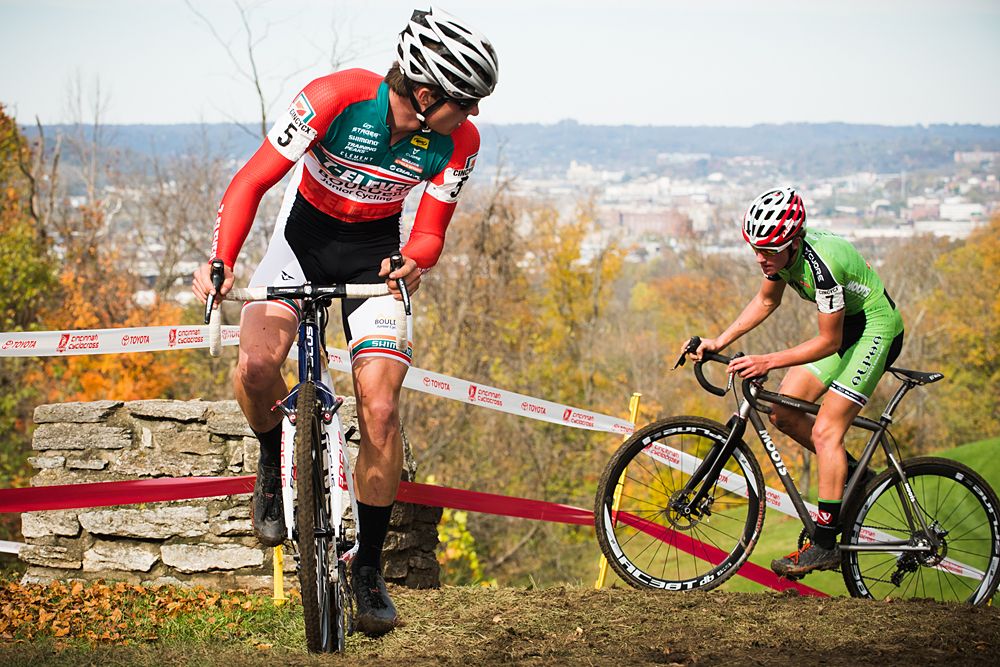 A Boulder Junior Cycling Team rider looks back as Evan Clouse makes their way up a tough muddy section of the course.