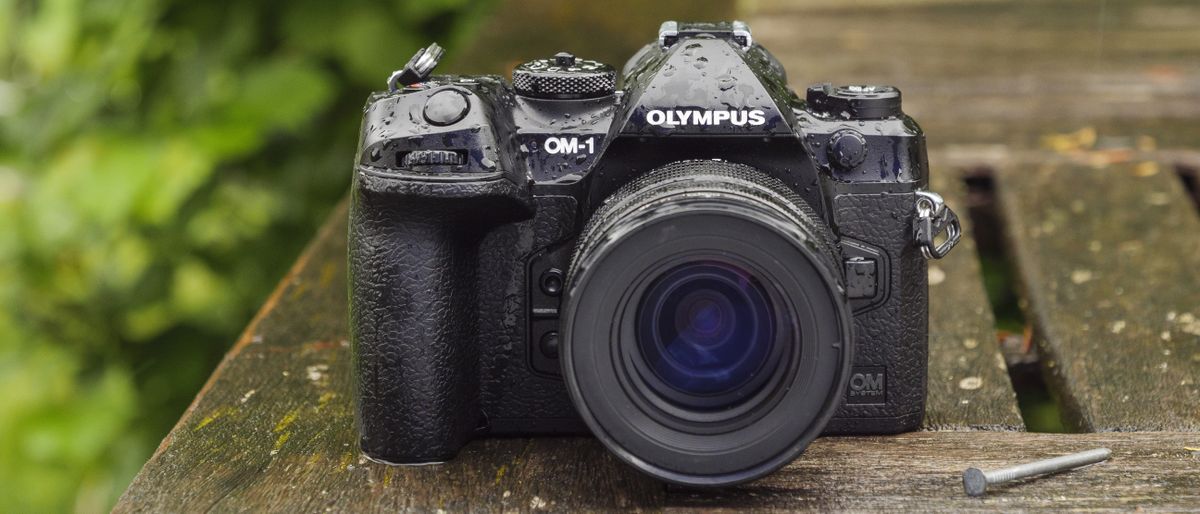 The OM System OM-1 camera on a wooden table