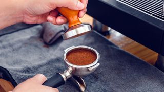 Tamping a puck of espresso