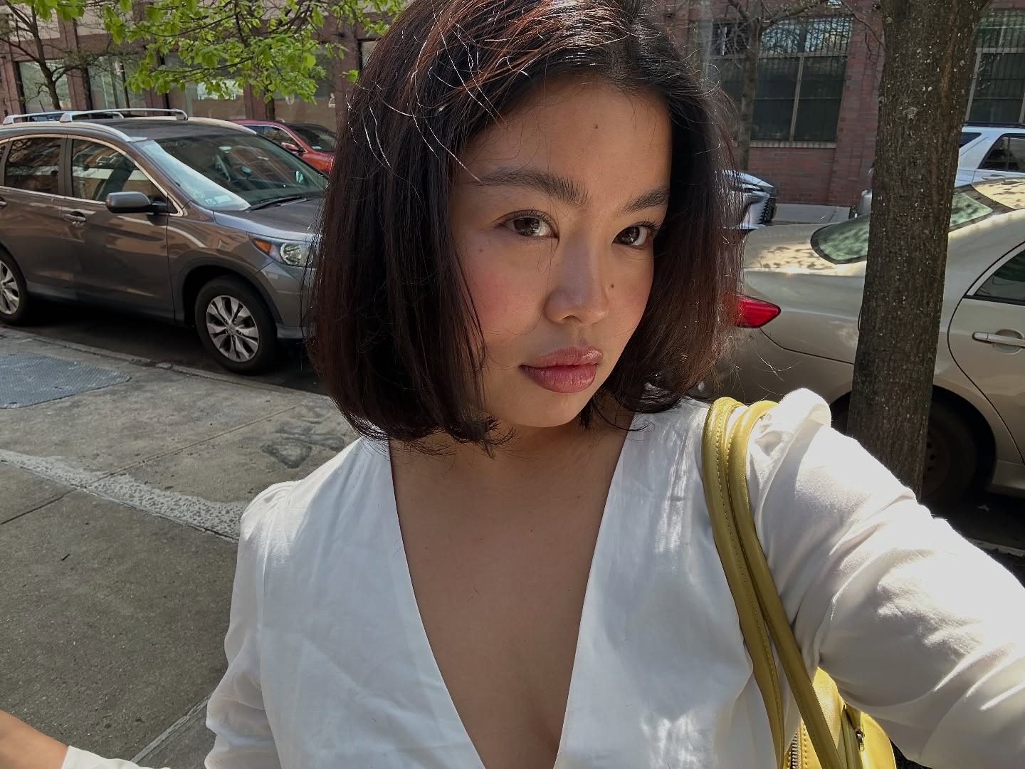 A woman with glowing skin taking a selfie
