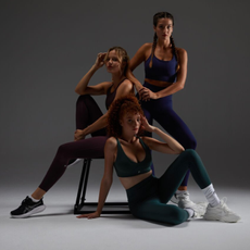 Three models wearing Fabletics leggings and sport bras